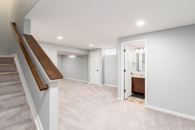 interior space with stairway, baseboards, light colored carpet, and recessed lighting