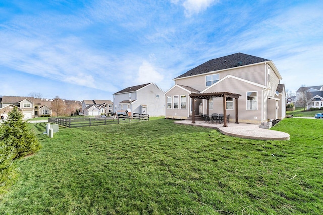 rear view of house with a residential view, a pergola, a yard, and a patio