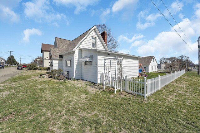 28 John St, Mount Sterling, OH 43143 - view of side of property featuring a chimney and roof with shingles