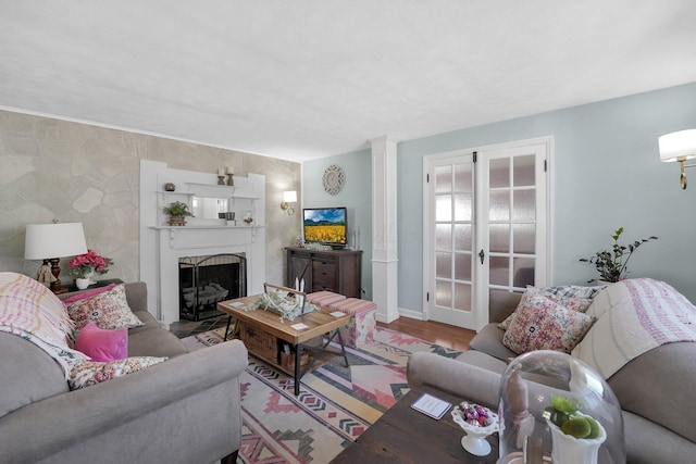 28 John St, Mount Sterling, OH 43143 - living area with a fireplace, wood finished floors, and decorative columns
