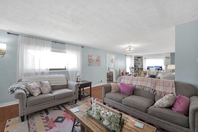 28 John St, Mount Sterling, OH 43143 - living room with wood finished floors, built in shelves, and a textured ceiling