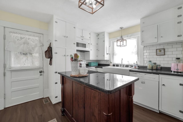 28 John St, Mount Sterling, OH 43143 - kitchen featuring white appliances, dark countertops, dark wood-style floors, white cabinets, and decorative backsplash