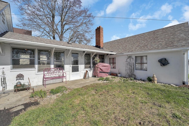 28 John St, Mount Sterling, OH 43143 - back of property featuring a chimney, a yard, roof with shingles, and stucco siding