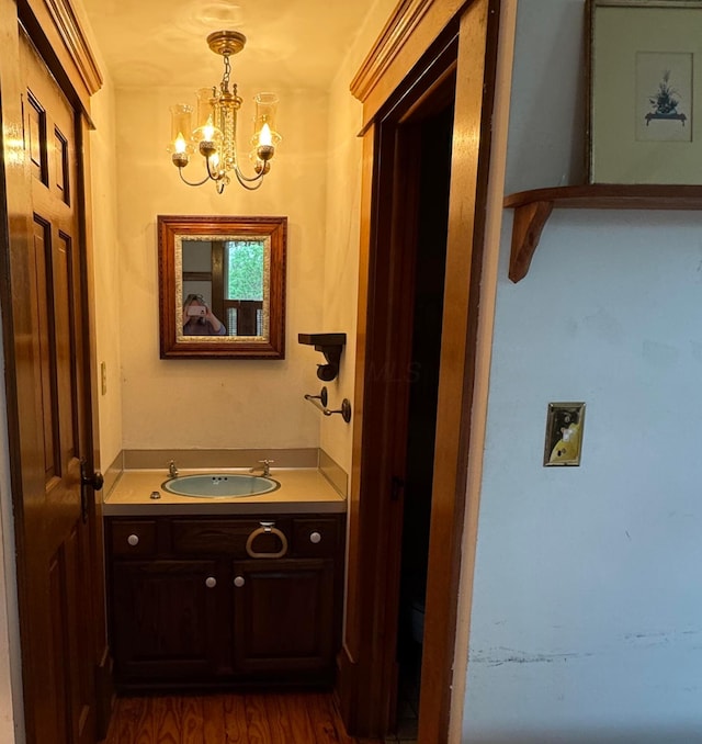 4175 Reynoldsburg Baltimore Rd NW, Baltimore, OH 43105 - bathroom featuring wood finished floors, vanity, and an inviting chandelier