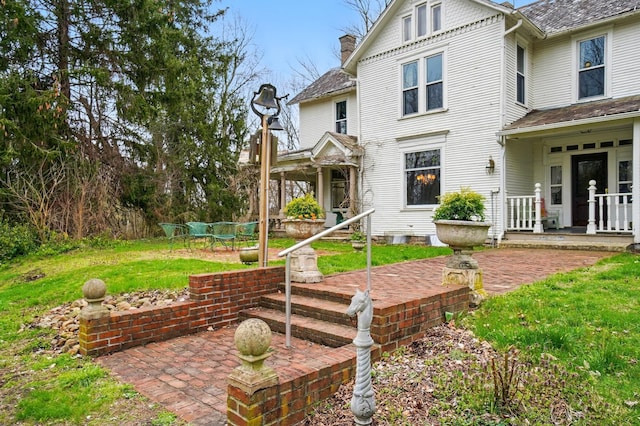 4175 Reynoldsburg Baltimore Rd NW, Baltimore, OH 43105 - rear view of property with a yard, a chimney, and a patio