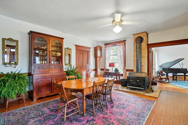 4175 Reynoldsburg Baltimore Rd NW, Baltimore, OH 43105 - dining room featuring a ceiling fan, a wood stove, and wood finished floors