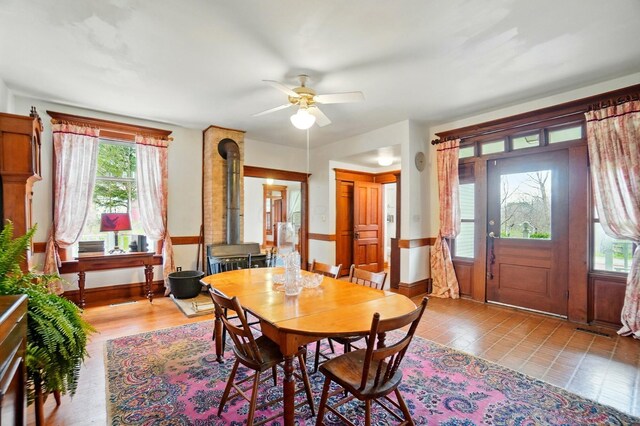 4175 Reynoldsburg Baltimore Rd NW, Baltimore, OH 43105 - dining room featuring visible vents, ceiling fan, baseboards, and a wood stove
