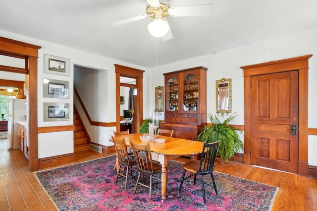 4175 Reynoldsburg Baltimore Rd NW, Baltimore, OH 43105 - dining room with light wood-type flooring, baseboards, visible vents, stairs, and ceiling fan