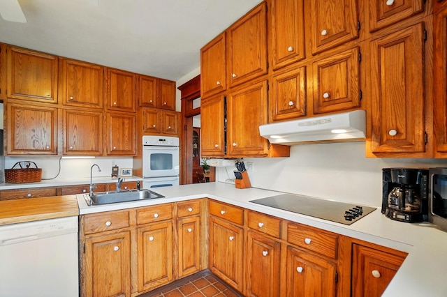 4175 Reynoldsburg Baltimore Rd NW, Baltimore, OH 43105 - kitchen with a sink, white appliances, brown cabinets, light countertops, and under cabinet range hood