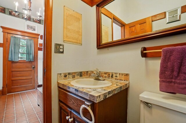4175 Reynoldsburg Baltimore Rd NW, Baltimore, OH 43105 - half bathroom with tile patterned floors, vanity, toilet, a notable chandelier, and visible vents