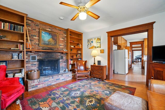 4175 Reynoldsburg Baltimore Rd NW, Baltimore, OH 43105 - living area with a ceiling fan, wood finished floors, and a fireplace