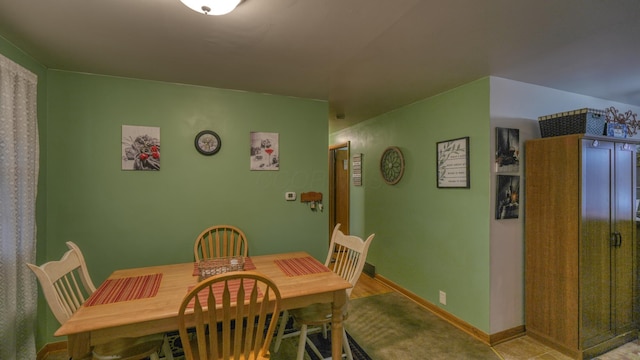 dining space featuring baseboards
