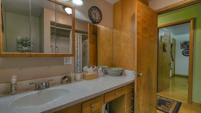 bathroom with vanity and wood finished floors