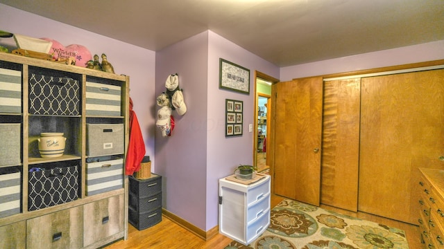 interior space featuring wood finished floors and baseboards