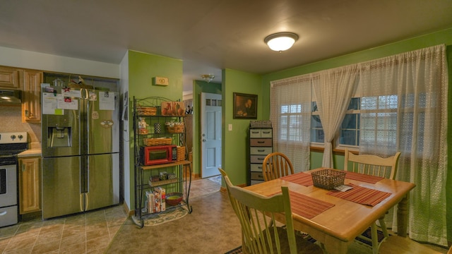 dining area featuring light tile patterned flooring