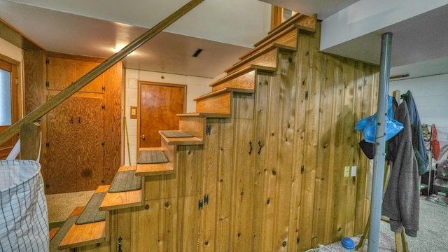 stairway with wood walls