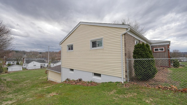 view of home's exterior featuring a yard and fence