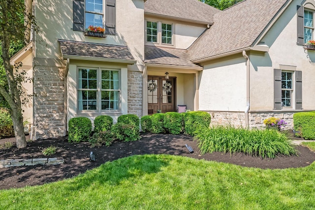 9047 Sequoia Ct, Plain City, OH 43064 - property entrance with stone siding, stucco siding, french doors, and roof with shingles