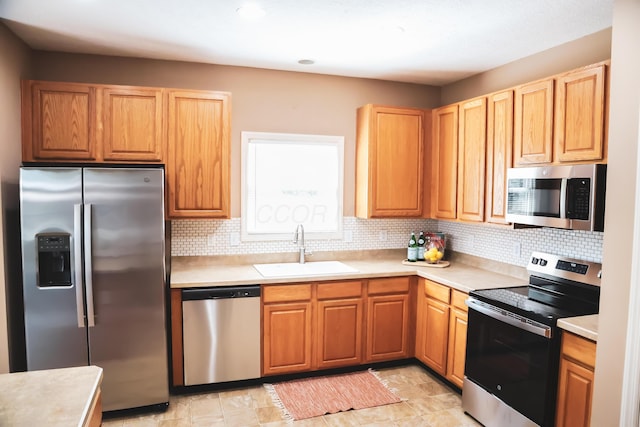 7720 Marrisey Loop, Galena, OH 43021 - kitchen featuring appliances with stainless steel finishes, a sink, light countertops, and backsplash