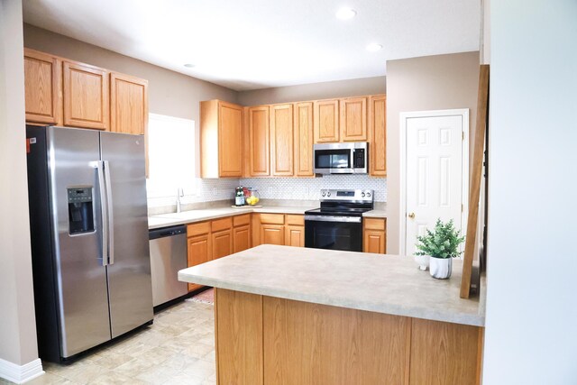 7720 Marrisey Loop, Galena, OH 43021 - kitchen featuring stainless steel appliances, light brown cabinets, light countertops, tasteful backsplash, and a peninsula