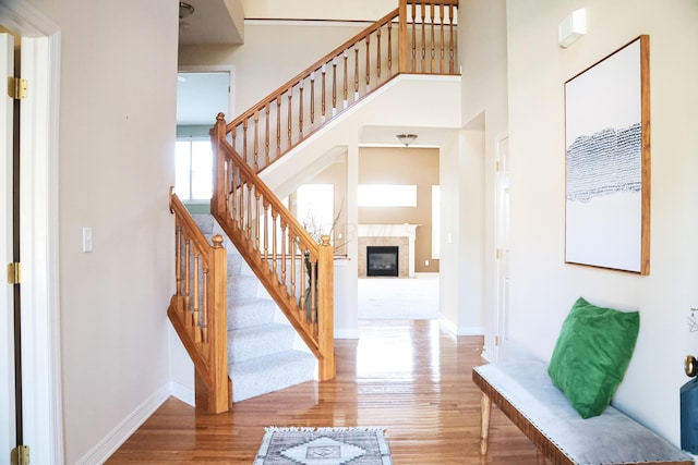7720 Marrisey Loop, Galena, OH 43021 - stairway featuring wood finished floors, baseboards, and a tile fireplace