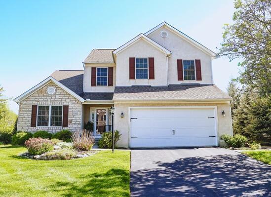 7720 Marrisey Loop, Galena, OH 43021 - traditional home with concrete driveway, an attached garage, and stucco siding