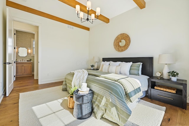 bedroom with beamed ceiling, visible vents, wood finished floors, an inviting chandelier, and baseboards
