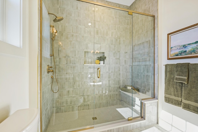 full bath with toilet and a shower stall