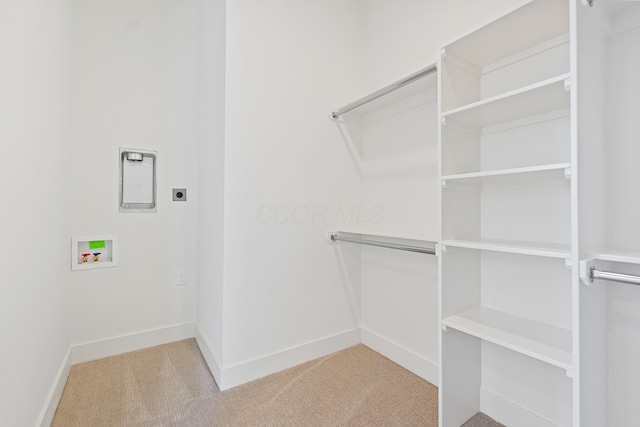 spacious closet with light colored carpet