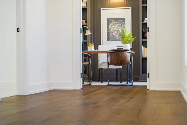 bar featuring baseboards and wood finished floors