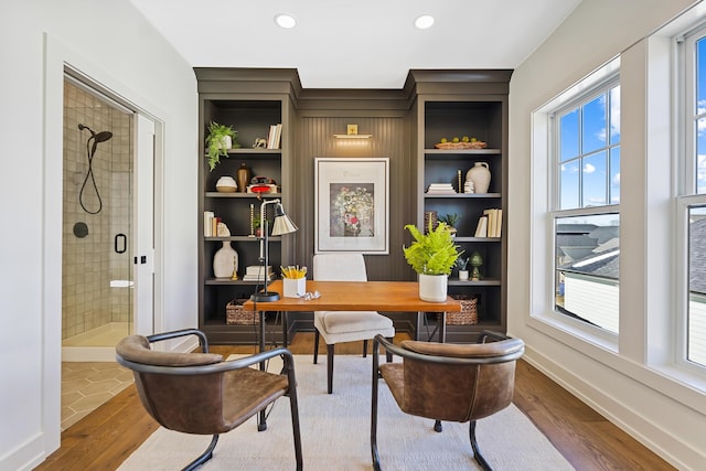 office area featuring a wealth of natural light, baseboards, and wood finished floors