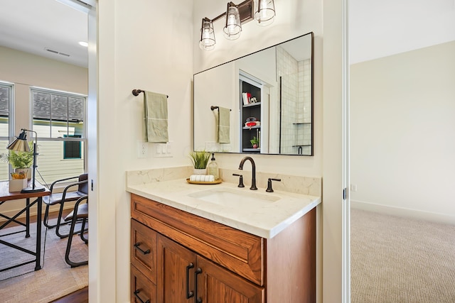 bathroom with vanity, baseboards, and visible vents