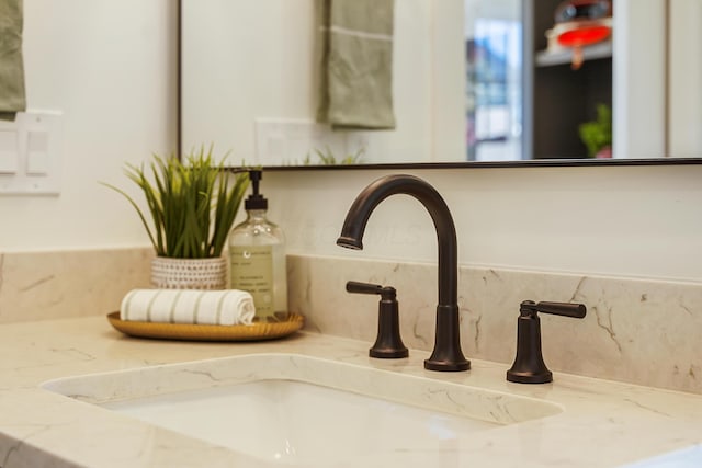 room details with decorative backsplash and a sink