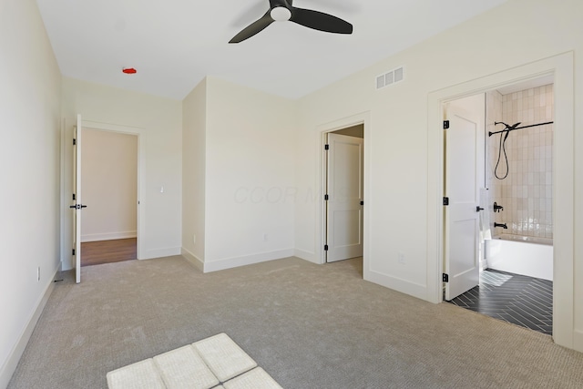 unfurnished bedroom with visible vents, carpet floors, baseboards, and a ceiling fan