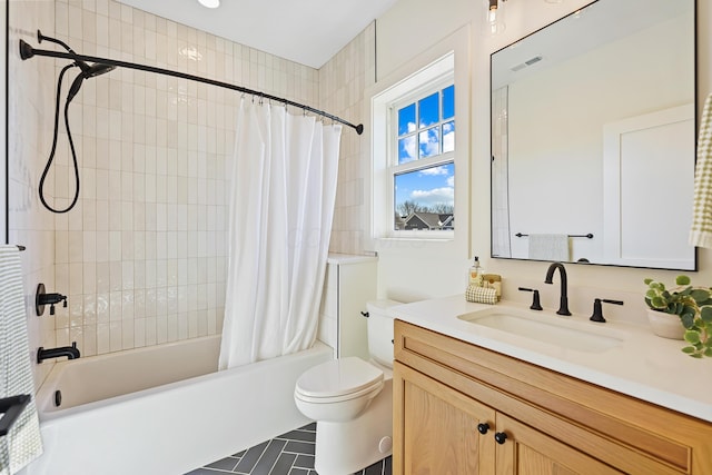 bathroom with vanity, toilet, visible vents, and shower / bath combo