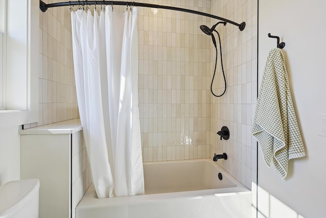 bathroom with shower / tub combo with curtain and toilet
