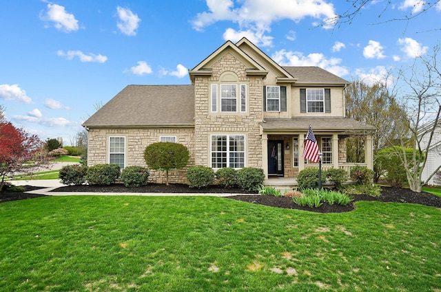 view of front of home featuring stone siding, a front lawn, a porch, and roof with shingles