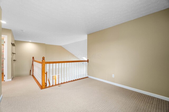 hall with carpet floors, baseboards, recessed lighting, and an upstairs landing