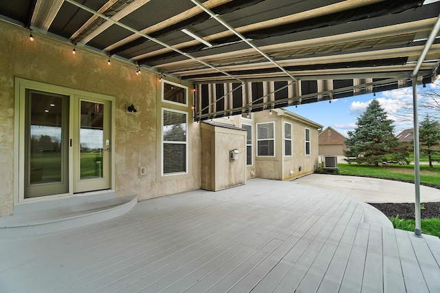wooden deck featuring central air condition unit