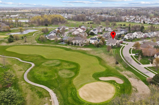 aerial overview of property's location with nearby suburban area, a nearby body of water, and a local golf course