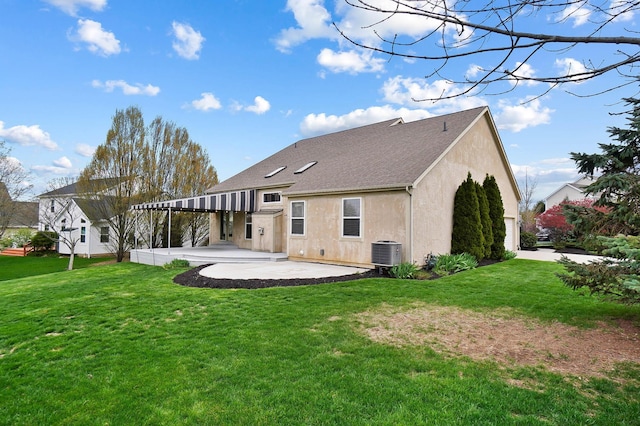 back of property with a patio area, a lawn, stucco siding, and a shingled roof