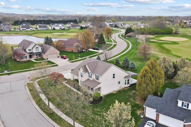 aerial perspective of suburban area with a local golf course and a large body of water