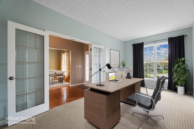 office space featuring carpet flooring, baseboards, wood finished floors, and a textured ceiling