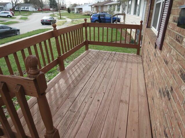 deck featuring a residential view and a yard