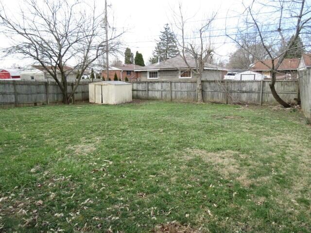 view of yard featuring an outbuilding and a fenced backyard