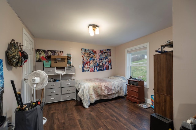 bedroom with dark wood finished floors