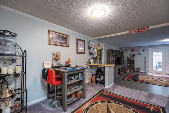 interior space featuring baseboards, carpet floors, a textured ceiling, and crown molding
