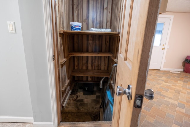 view of sauna / steam room with baseboards and stone finish floor