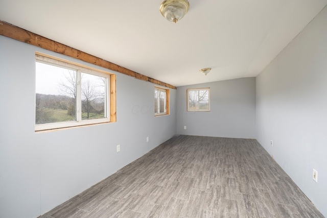 unfurnished room with wood finished floors