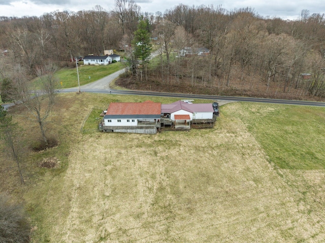 drone / aerial view featuring a wooded view